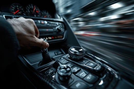 A person driving a car with the steering wheel photo