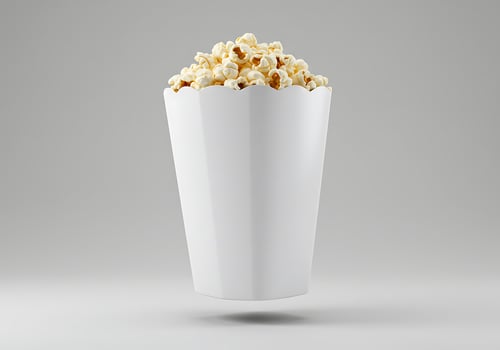 Popcorn Bucket Overflowing in a White Container on Gray Background photo