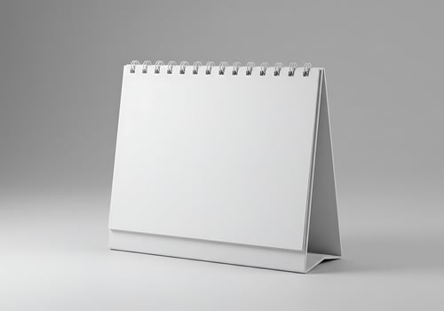 Blank Desk Calendar Mockup on White Surface for Planning and Scheduling photo
