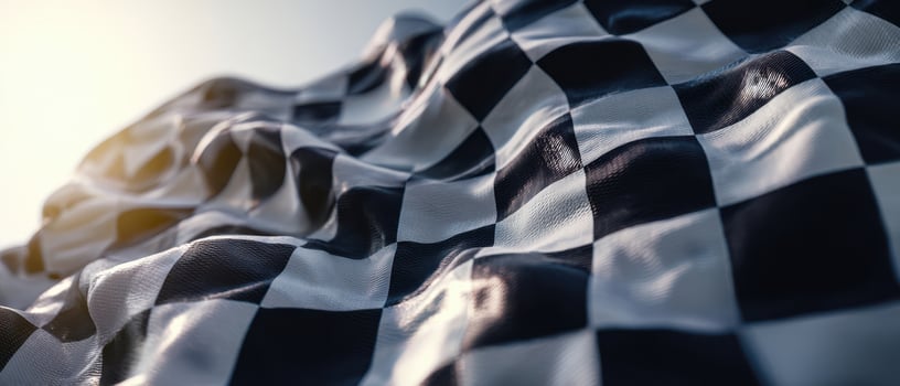 The checkered flag waving dramatically under the sunlight on a racecourse. photo