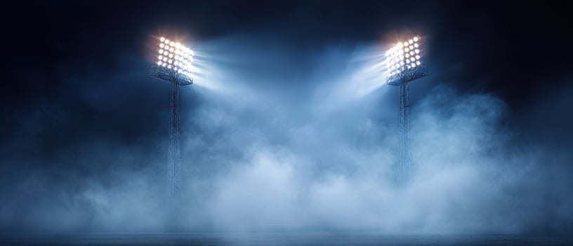 The dramatic stadium floodlights illuminating a misty night scene photo