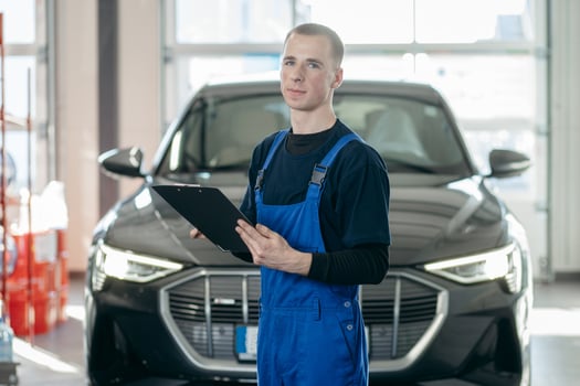 Inspector checks the work of a mechanic in a car repair shop. photo