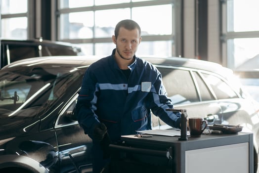 Adult auto mechanic in a car repair shop photo
