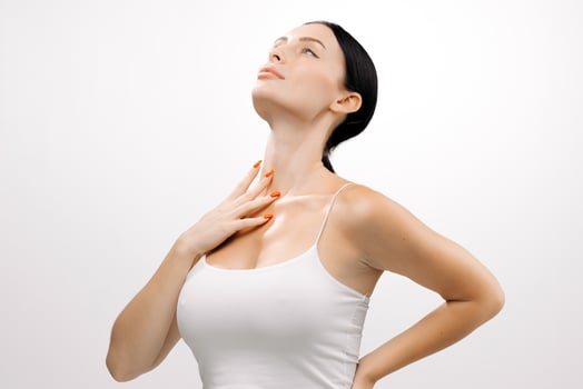 Woman with clear skin poses gracefully against a white background, showcasing her beauty and confidence, highlighting the importance of skincare and self-care routines photo