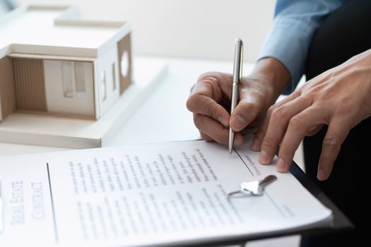 Signing Contract. Real estate agent completing paperwork for property sale. photo