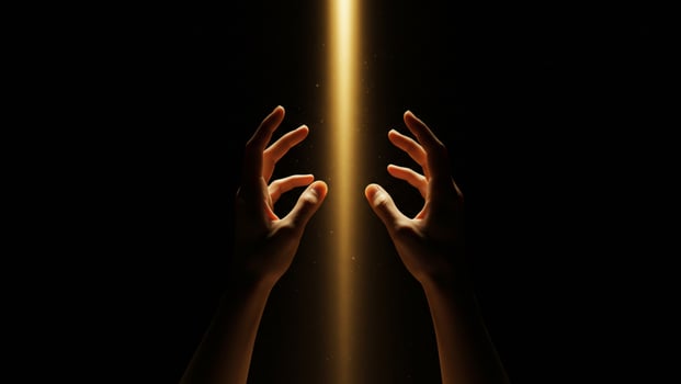 Human hands reaching for radiant golden light in a dark spiritual setting photo