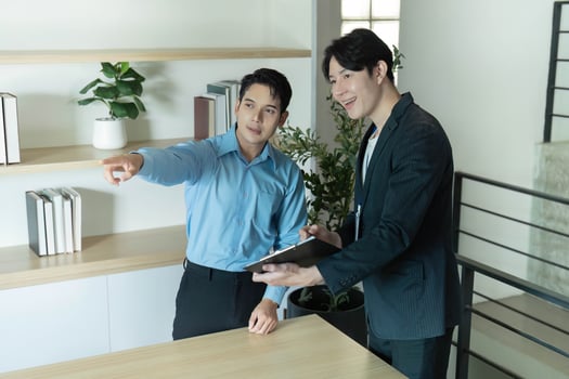 Real Estate Presentation. Agent showing property features to client in modern office. photo