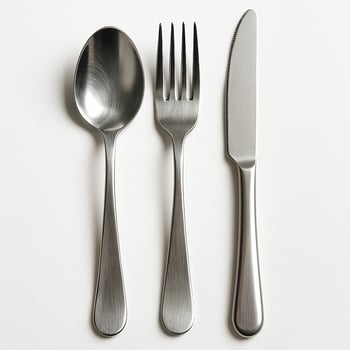 Stainless steel spoon, fork, and knife on white background photo