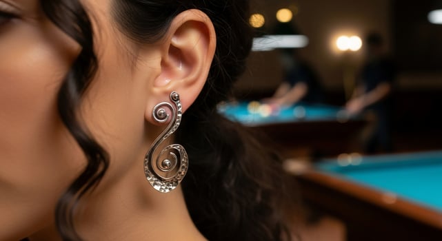 A woman wearing earrings in front of a pool table photo