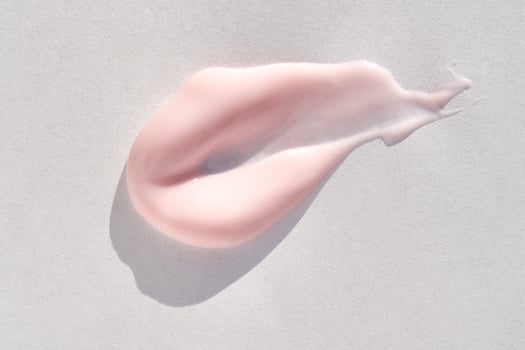 close up of pink cream swirl on white background skincare, cosmetic product, beauty, moisturizer, texture. photo