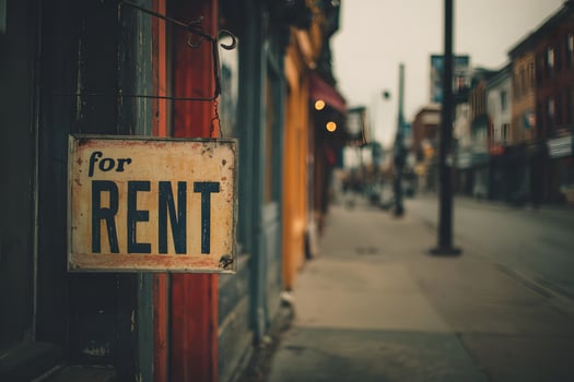 Vacant Storefront with For Rent Sign on Quiet Street photo