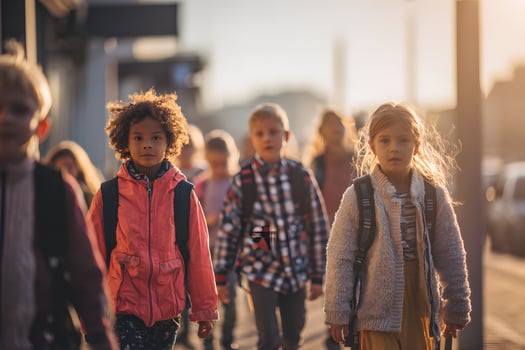 Children Walking to School with Backpacks in Morning Light photo