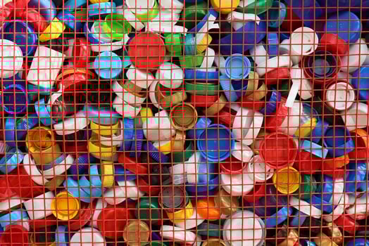 A Vibrant and Colorful Collection of Plastic Bottle Caps Arranged in a Grid Format photo