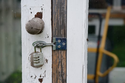 Weathered Wooden Door with Padlock photo
