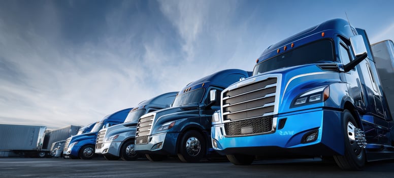 The fleet of modern blue trucks parked under a dramatic sky photo