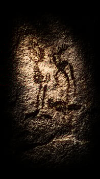 Ancient Cave Art Glowing Under Dramatic Light, Revealing History. photo