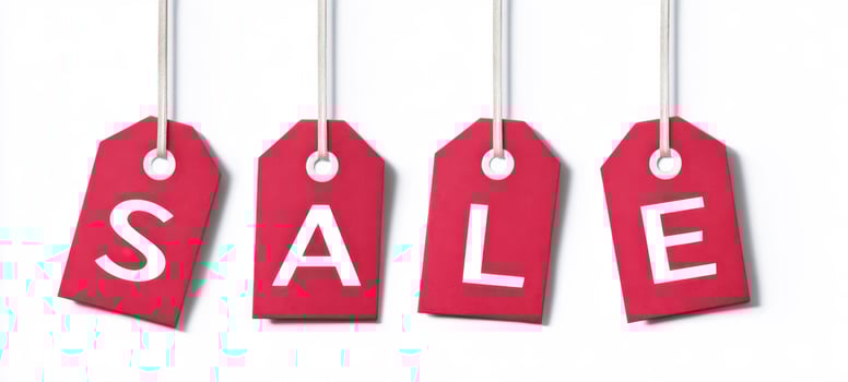 The vibrant red sale tags announcing discounts for shoppers and bargain hunters photo