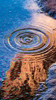 Ripples on Water Surface Reflecting Warm Sunlight and Blue Sky. photo