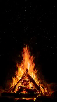 Roaring Campfire with Glowing Embers and Twinkling Night Sky. photo