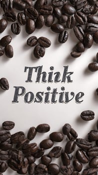 Roasted Coffee Beans with Think Positive Text on White Surface. photo