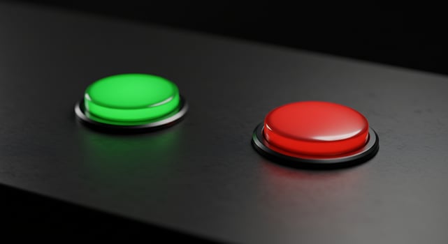 Two glowing push buttons, one red and one green, on a dark panel. photo