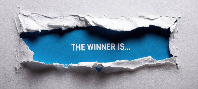 The torn paper revealing the winner's announcement in a vibrant blue background. photo