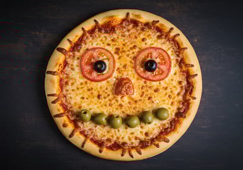 A pizza with a face drawn on it photo
