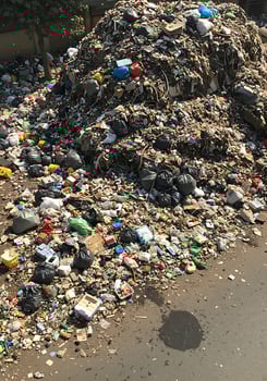 A pile of garbage on the side of the road photo