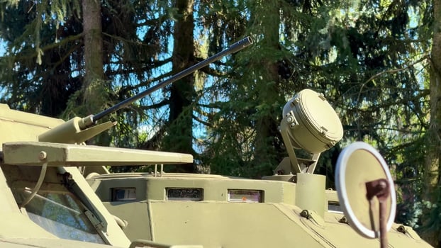 A Military Armored Vehicle Positioned Strategically in its Natural Surroundings for Operations photo
