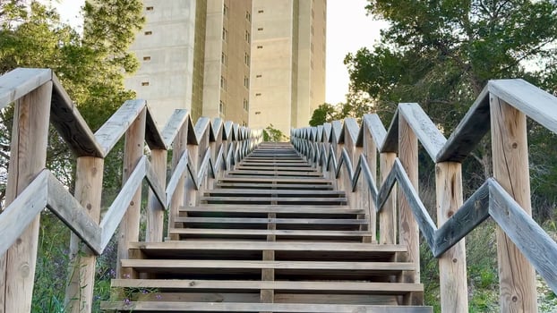 Stunning Architectural View Featuring a Tall Building Surrounded by Beautiful Wooden Steps photo