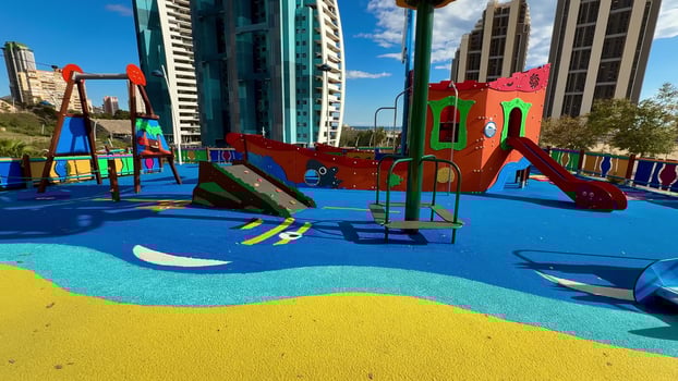A Vibrant Playground Featuring a Scenic City Background in a Beautiful Urban Setting photo