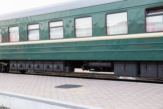 Detailed view of train suspension system and wheel assembly at a railway station photo