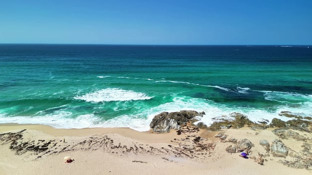Enjoy breathtaking beach views with turquoise waves and serene shores, ideal for relaxation photo