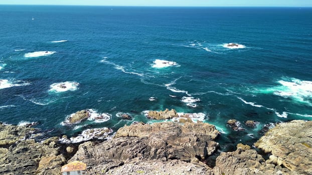 Stunning Aerial Views Showcasing Rocky Coastline Embraced by Turquoise Waters and Ancient Ruins photo
