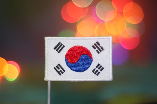South Korea national flag with vivid festive bokeh background. Artistic representation of K-culture, national unity, eco-friendly travel, and joyful holiday celebrations. photo