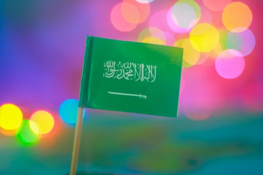 Saudi flag set against vivid bokeh lights. Symbolizes national pride, unity, eco-tourism, and celebration. Ideal for campaigns related to Middle East Green Initiative or cultural events. photo