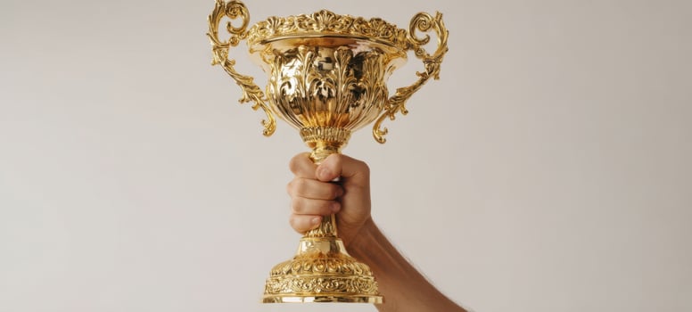 The Golden Trophy Held High Celebrating Achievement and Success photo