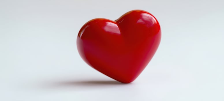 The glossy red heart symbolizing love and affection on a minimalist background. photo