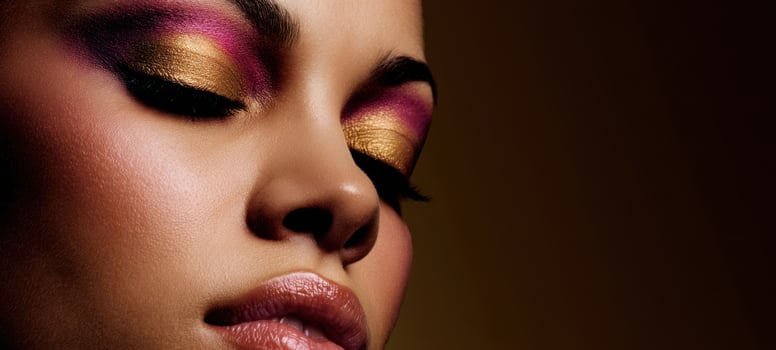 The stunning effects of vibrant makeup on a beautiful model's face. photo