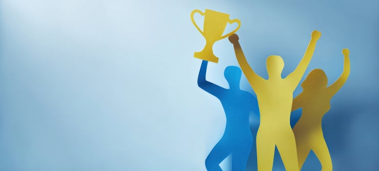 The victory celebration with silhouettes holding a trophy against a blue background. photo
