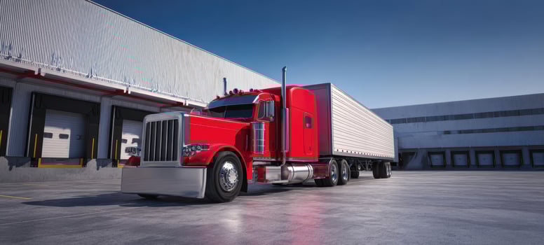 The striking red truck parked in an industrial loading area photo