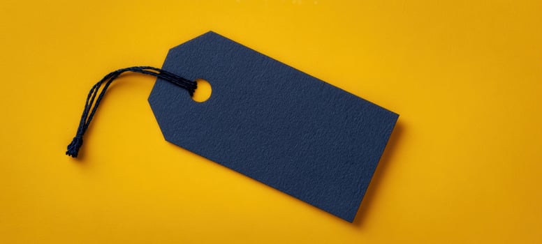 The simple blank tag against a vibrant yellow background for creative branding. photo