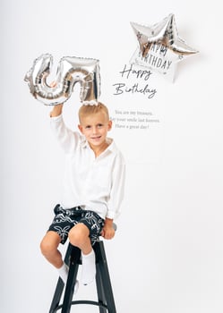 Smiling Boy Celebrating 5th Birthday with Balloon photo