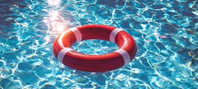 The vibrant lifebuoy floating in a sparkling pool water scene. photo