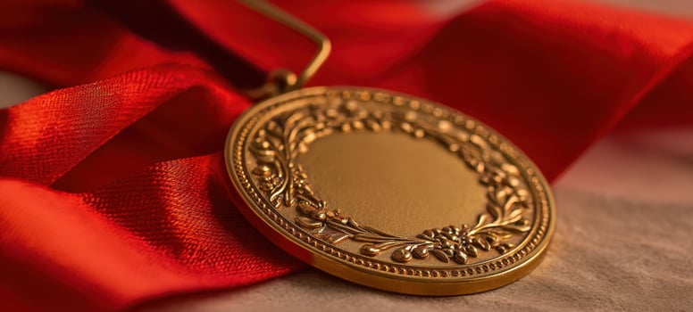 The gold medal with red ribbon showcasing accomplishment and prestige. photo