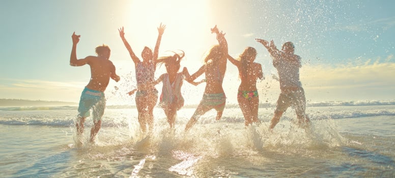 The joy of friends splashing in the ocean at sunset. photo
