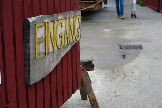 Rustic Eingang Sign on Red Wall at flensburg Museumshafen photo
