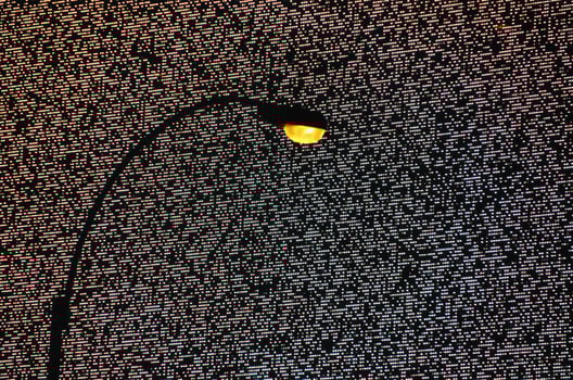 a classic old street lamp in New York in front of a large LED dot matrix advertising billboard photo