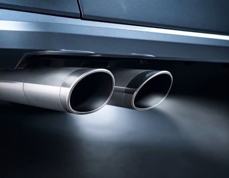 Close-up of a car exhausting gas fumes photo