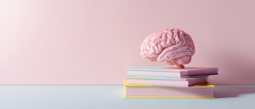 The brain floating above a stack of colorful educational books. photo